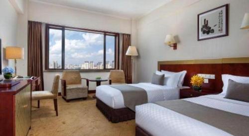 Postel nebo postele na pokoji v ubytování Kunming Jinjiang Hotel
