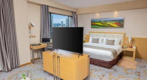 Postel nebo postele na pokoji v ubytování Kunming Jinjiang Hotel
