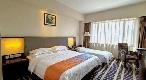 Postel nebo postele na pokoji v ubytování Kunming Jinjiang Hotel