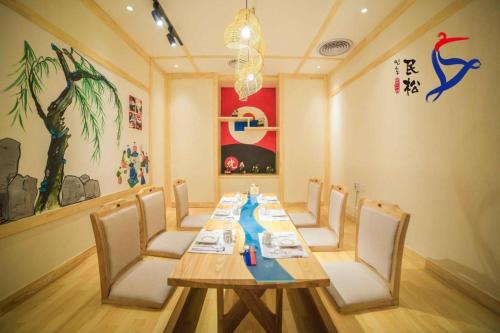 a dining room with a long table and chairs at Yanji Yanbian International Hotel in Yanji