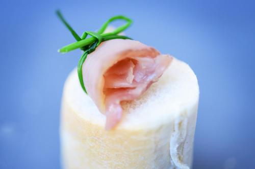 a piece of food with a ham on top at Das Alte Rathaus in Egna