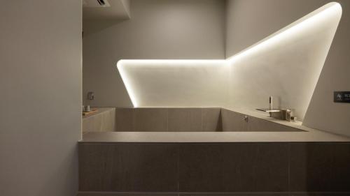 a bathroom with a bath tub with a mirror at Stay Passport Airplane Guri in Guri