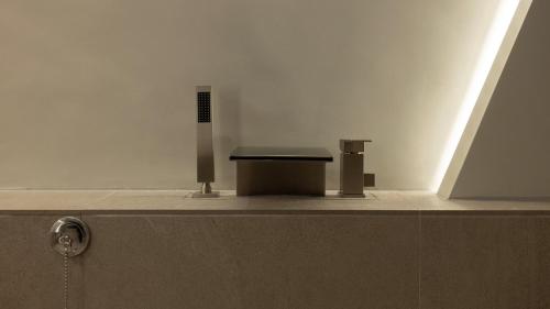 a bench in a bathroom with a white wall at Stay Passport Airplane Guri in Guri