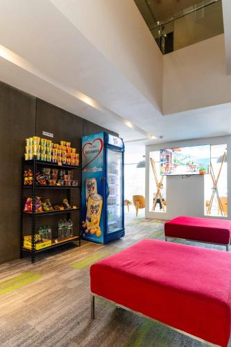 a room with a soda vending machine next to a store at T+ Hotel Butterworth in Butterworth