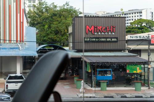 a street view of a mitzi outpost in a city at T+ Hotel Butterworth in Butterworth