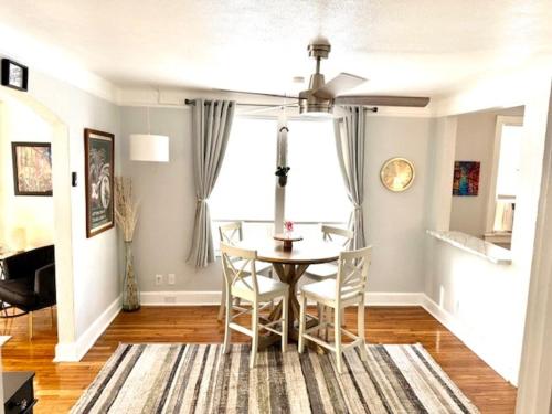 a living room with a dining room table and chairs at Renovated charming 2BR close to French Quarter in New Orleans