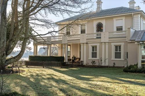 a large white house with a large yard at Calstock Estate 1831 in Deloraine