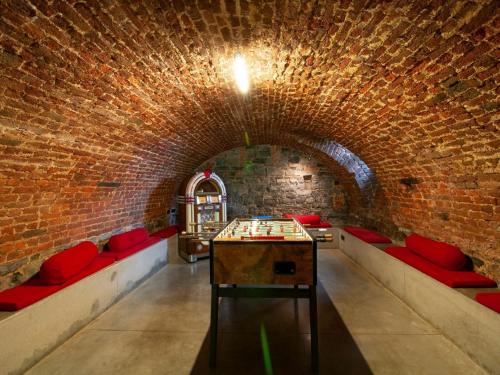 a room with a pool table in a brick wall at Holiday home in Denee for 21 people in Denée