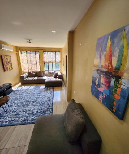 a living room with a couch and a painting on the wall at Carolina Point Resort in Crown Point