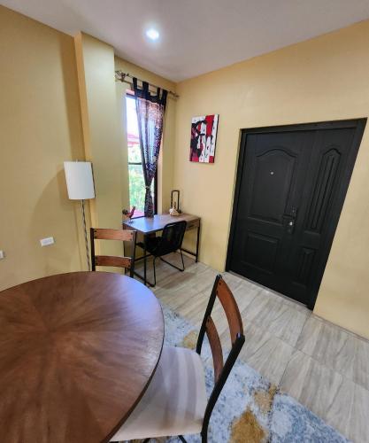 a dining room with a table and chairs and a black door at Carolina Point Resort in Crown Point