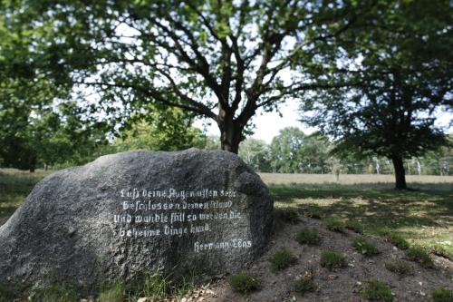 a rock with writing on it in a park at Hotel Schäferhof in Schneverdingen