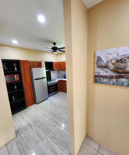 a kitchen with wooden cabinets and a white refrigerator at Carolina Point Resort in Crown Point