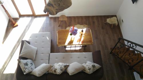 a living room with a white couch and a table at Apartment Mond in Virpazar