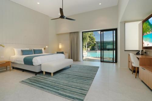 a bedroom with a bed and a living room at Mindil Beach Casino Resort in Darwin