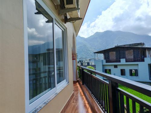 a balcony with a view of the mountains at Om Homestay in Rishīkesh