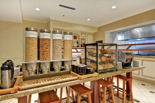 a kitchen with a counter with many different types of food at Hilton Garden Inn Oshkosh in Oshkosh