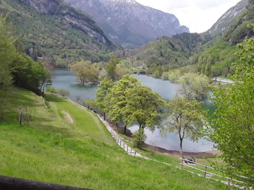 a view of a lake in a valley with mountains at Appartamento finestra sul parco in Comano Terme
