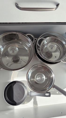 a stove top with four pots and pans on it at Nisay Home, Apart Suite, N1 in Ludwigsburg