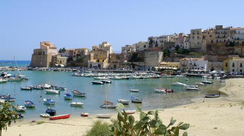 a bunch of boats in a harbor with buildings at Blue Suite in Castellammare del Golfo