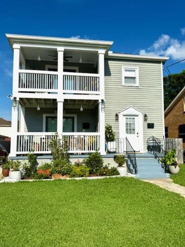 a large house with a balcony and a yard at Renovated charming 2BR close to French Quarter in New Orleans