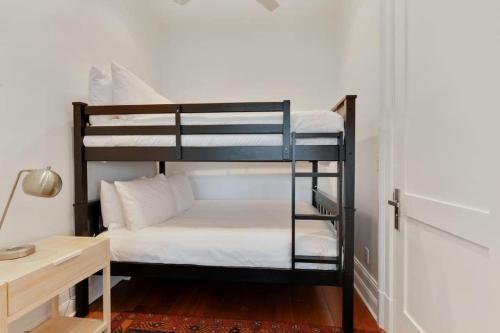 a room with two bunk beds and a desk at Roami at Factors Row in New Orleans