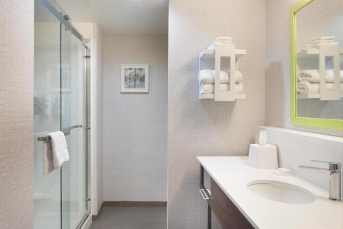 a bathroom with a sink and a shower at Hampton Inn Evergreen in Evergreen