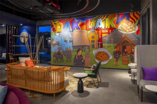 a room with a wall with a colorful mural at Tru by Hilton Buon Ma Thuot City Centre in Buon Ma Thuot