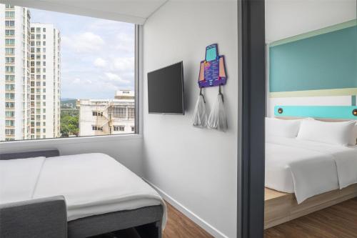 a hotel room with a bed and a window at Tru by Hilton Buon Ma Thuot City Centre in Buon Ma Thuot