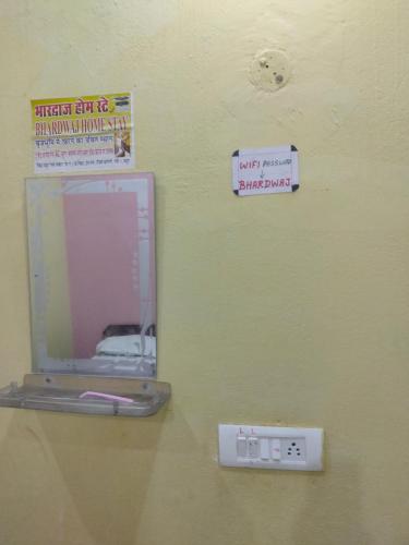 a mirror on a wall with signs on it at Bhardwaj Home Stay in Mathura