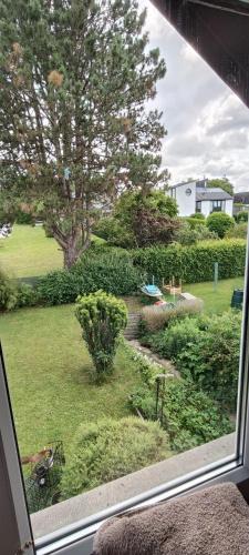 a view of a garden from a window at Bed vue sur vallée de la Meuse Namur in Bouge