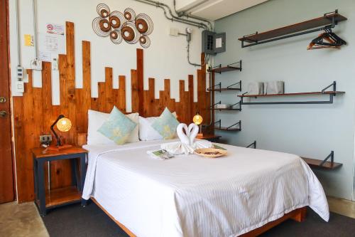 a bedroom with a bed with a white comforter at AV Suites in Puerto Galera