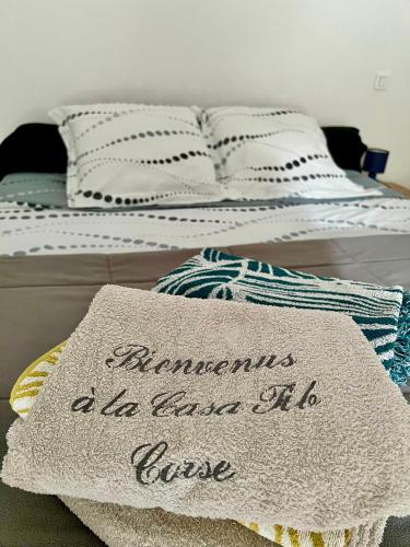 a bed with a mattress with a sign on it at Mini Villa Pascal Paoli avec piscine - proche mer in Prunelli-di-Fiumorbo