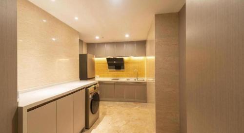 a kitchen with a sink and a washing machine at Hefei Parkview Hotel in Hefei
