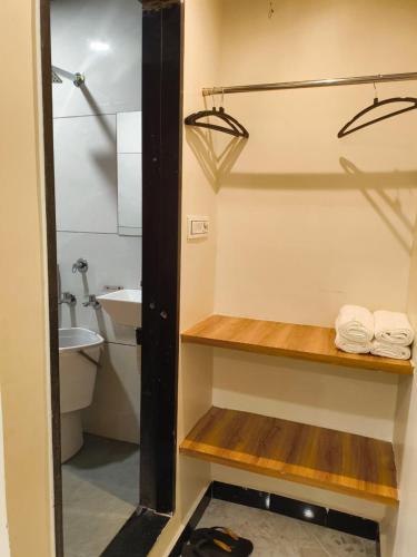 a bathroom with a sink and a shower with towels at Shri ShyamRaj Hotel Ujjain in Ujjain