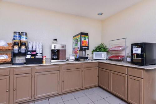a fast food restaurant with a counter with food at Baymont by Wyndham Acworth in Acworth