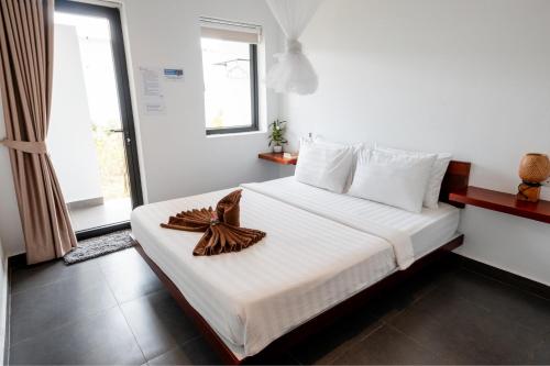 a bedroom with a bed with a bow on it at Onederz Koh Rong in Koh Rong