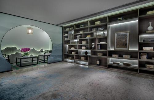 a large room with a large book shelf at Yuan Culture Hotel Shenzhen World Shajing in Shenzhen