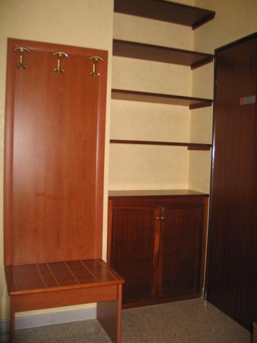 a closet with wooden cabinets and a wooden table at Hotel Bed & Breakfast Minu' in Paravati