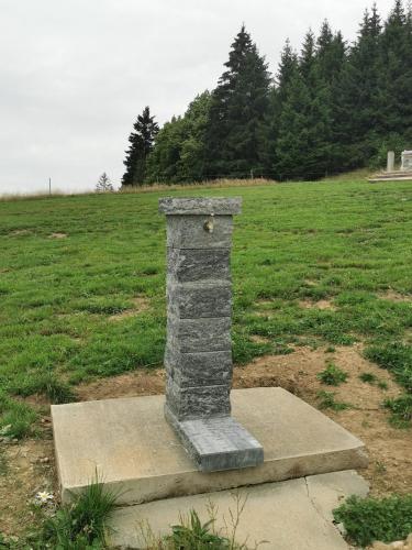 a stone pillar in the middle of a field at AA Frame Retreat Fundata in Fundata