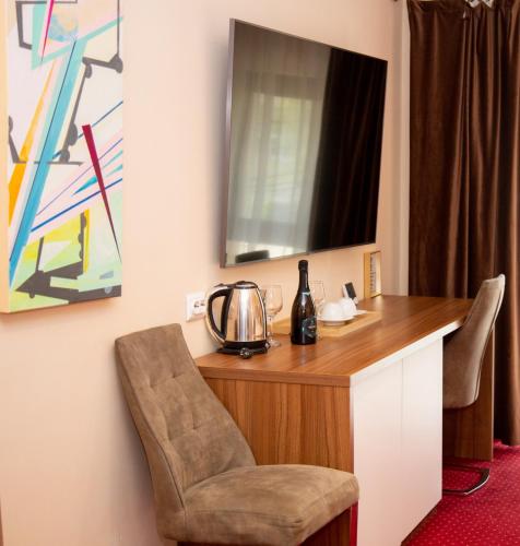 a room with a desk with a chair and a mirror at BUCUR 9 in Bucharest