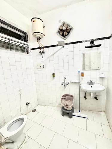 a bathroom with a toilet and a sink at Modern 4 BHK in Hyderabad