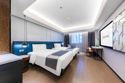 Ένα ή περισσότερα κρεβάτια σε δωμάτιο στο Yitel Premium Hotel Shanghai Xuhui