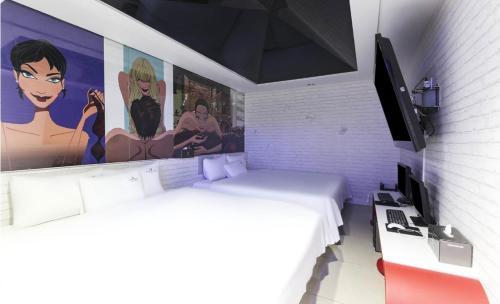 a bedroom with a large painting on the wall at Songjeong V Hotel in Busan