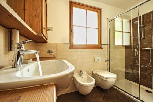 a bathroom with a sink and a toilet and a shower at Appartamento Zepp in Bormio