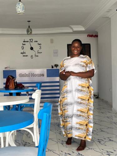 a woman in a dress standing in a room at Cairo Pyramids View Hostel & Apartment in Cairo
