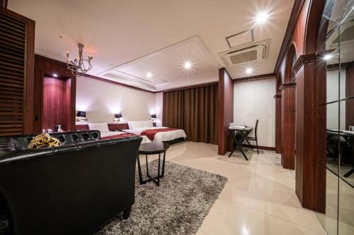 a hotel room with a bed and a living room at Hotel Floce in Bucheon
