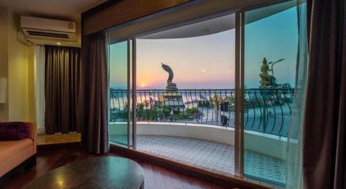a living room with a view of a balcony at LANDMARK NAKHONPHANOM HOTEL in Nakhon Phanom