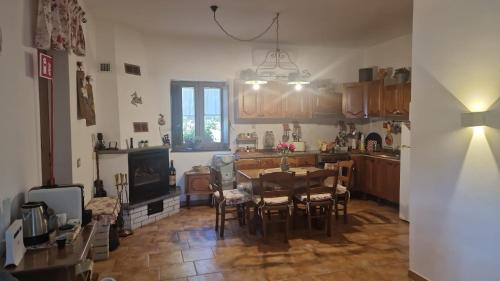 a kitchen and dining room with a table and chairs at La casa di Giulia in Bronte