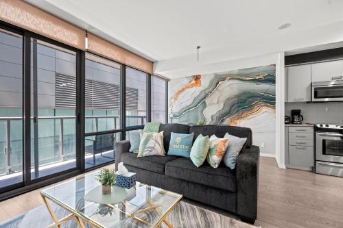 a living room with a couch and a glass table at Premium 1 Bedroom with City View in Toronto