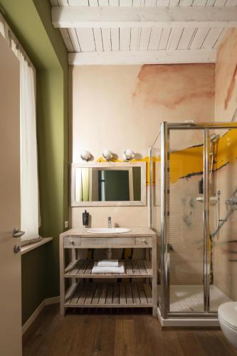 a bathroom with a sink and a shower at Locanda Cece e Simo in Bergamo